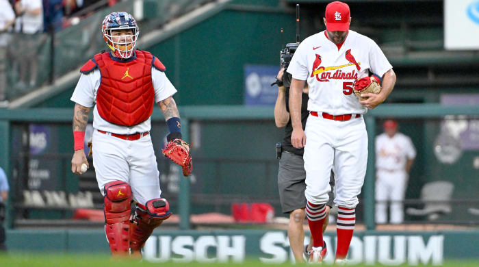 Sep 14, 2022; St. Louis, Missouri, USA;  St. Louis Cardinals catcher Yadier Molina (4) and starting pitcher Adam Wainwright (50) walk in from the bullpen before their 325th start as a battery breaking the MLB record before a game against the Milwaukee Brewers at Busch Stadium.